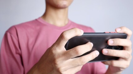 Fototapeta premium close-up of a man playing games on a smartphone