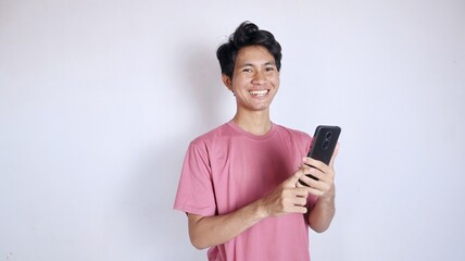 excited asian man with gesture holding smartphone