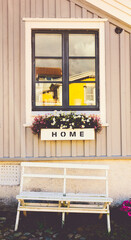 Home sign on window sill, rustic wooden house in Scandinavian style in Karlskrona Sweden - 748752559