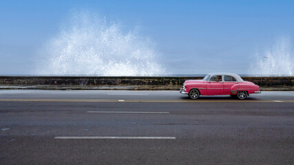 Fototapeta na wymiar Classic American car and splashing waves Havana Cuba