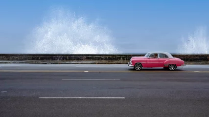 Tuinposter Classic American car and splashing waves Havana Cuba © Andrew Jalbert