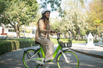 Asian businesswoman commute with her bicycle in the streets happily