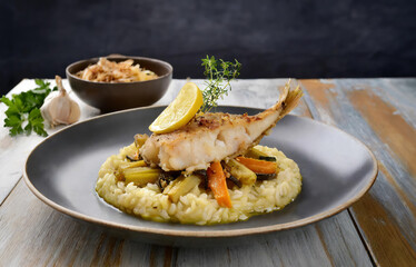 monkfish on lemon-ginger risotto with pan-fried vegetables and fermented garlic fried celery strips on top,	Generated image - 748756366