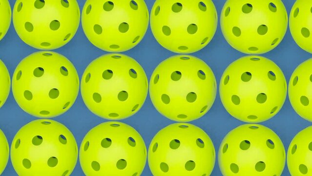 Rotating and zoom out view of several pickleball balls on court. Pickleball is America fastest growing sport