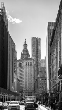 New York City street landscape with high rising buildings and cars in Soho, Lower Manhattan, USA, retro-style black and white photo