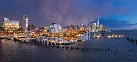 New York City, Little Island public park at twilight with view of the World Trade Center after a storm. Elevated park with amphitheater at Hudson River Park (Pier 55), West Village, Manhattan - 748769930
