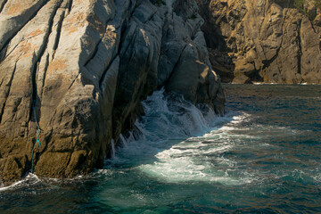 Rock formations by the sea, bathed by many waves, located in the Cabo Frio region, Rio de Janeiro, Brazil.