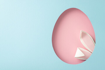 Whimsical Easter concept image. Top-view shot of endearing bunny ears protruding from a pink egg-like opening on a sky-blue background, space for personalized text
