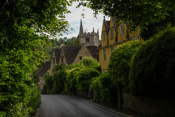Fototapeta na wymiar View of beautiful stone village through lush greenery in the English countryside