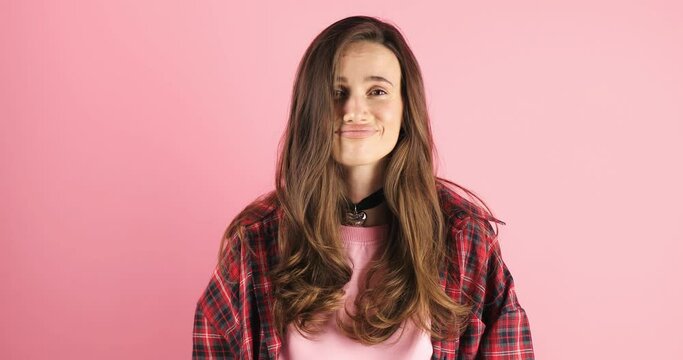 Fake, crying woman face in studio with hands gesture for sad, bullying or gesture on pink background. Tears, face and female joke, cry and sign on mockup with unhappy boo emoji or fist of loser.