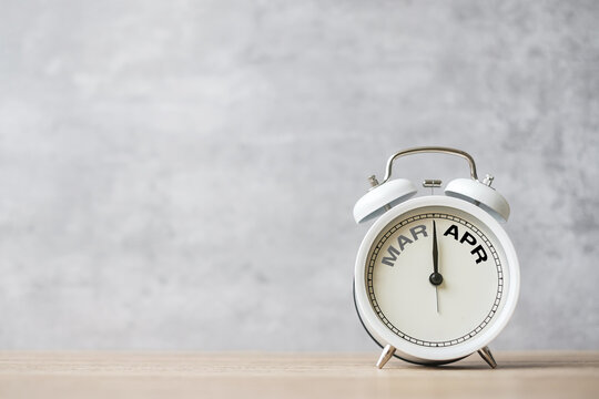 Hello April Changed from March month with vintage alarm clock on table background. Calendar, Monthly, New Start, Resolution, Goals, Plan, Action and Mission Concept