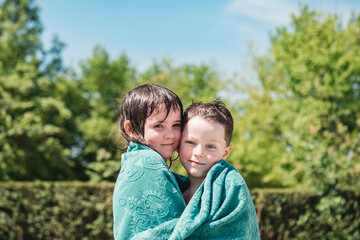 Fototapeta premium Adorable summer image of twin brothers hugging each other. Sign of union, love and tenderness.