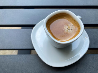 Espresso coffee with foam on a graphite gray table.