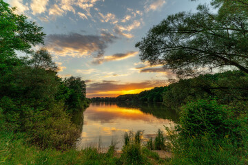 Fototapeta premium Warm day, landscape with sun and lake