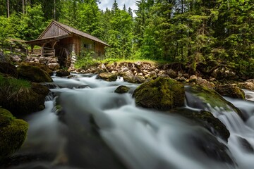 A wooden water mill on the river Schwarzbach near the Golling Waterfall in Austria