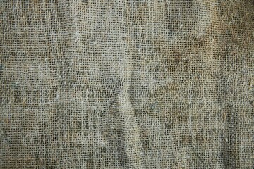 The texture of the old fabric is burlap.