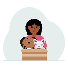 A little girl holds a cardboard box with a cat and a dog. The concept of rescue, help and care for pets.