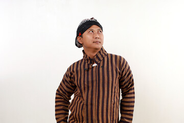 Asian man standing while looking above. Isolated on white