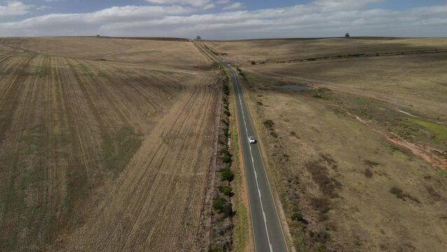 Road to Arniston at straight and long asphalt roads and white cars moving with a view from top