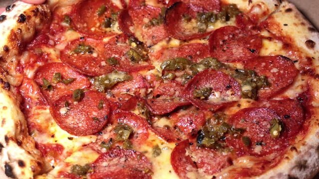 Close up, slow motion footage of a people taking piece of pizza.