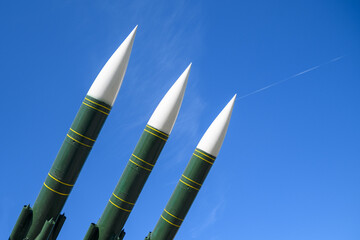 Anti-aircraft missiles aimed at the blue sky. Concept of defense, war, peace.