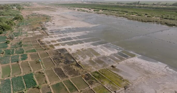 Aerial close-up fly over.  Encroaching soil salinity causing sodic soils which prevents water drainage deeming the land unless for vegetable farming, too much salt. Sahel, Drought, Climate change
