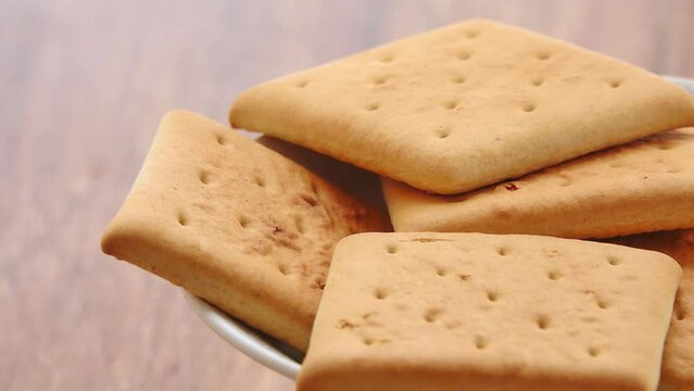 Gyration hardtack cookies on a plate on a wooden table background.