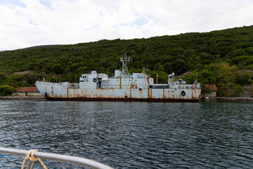 Old, rusty, decommissioned warships off the coast of the adriatic sea