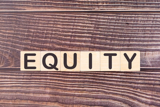 Word EQUITY made with wood building blocks on a wooden background