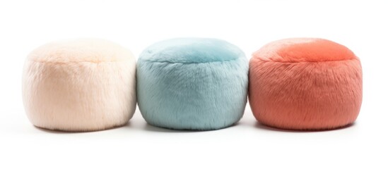 Three soft poufs of different colors - blue, green, and pink - are placed on a white background. The interior furniture items add a pop of color to any room setting.