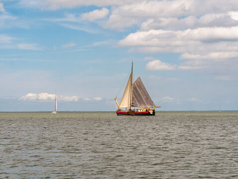 Historic tjalk charter ship sailing on IJsselmeer lake, Netherlands