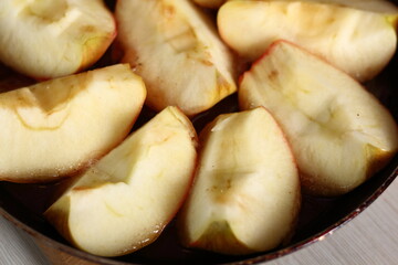 Naklejka na ściany i meble Precooked apples in frying pan. Making Apple Tarte Tatin with Cinnamon Series.