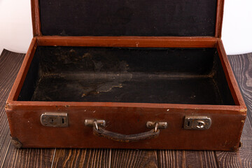 Old suitcase on the table against white background