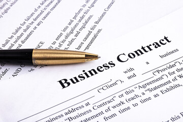 The pen lies on the contract. Business relationship concept.