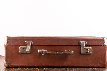 Old suitcase on the table against white background.