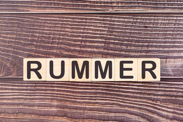 RUMMER word made with wood building blocks