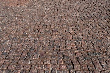 Fragment of rough brown paving stone surface
