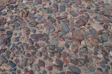 Closeup of rough pebble pavement background