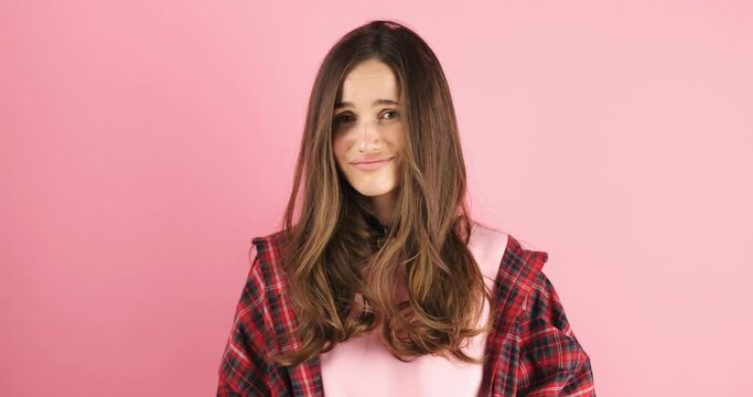 Brunette woman looking camera pointing fingers herself ask me no i do not need it. Girl point on her, waving her hands and say no isolated on pink background.