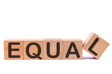 Word EQUAL is made of wooden building blocks lying on the table and on a light background.