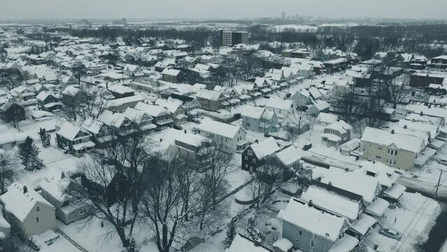 Flying over a snow-covered neighborhood during the middle of winter.