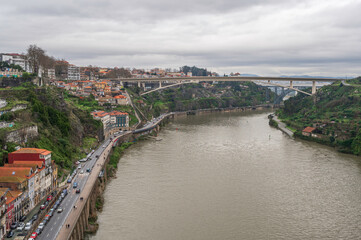 A view of the Douro River, Porto, looking east, from the top of Ponte Luis I bridge, on a cloudy day