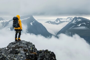 Mountaineer overlooking a foggy mountain range.
