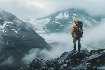 Mountaineer overlooking a foggy mountain range.