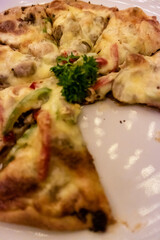 A close-up photo of Italian meat lover pizza at Belle Vue Roof Restaurant at GH Universal Hotel, Bandung, Indonesia