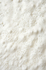 A close-up view of the whipped milkshake foam with delicate bubbles and airy texture.