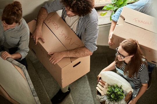 Group of young people moving into their new apartment