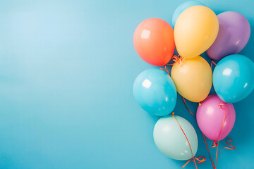 cheerful bunch of pastel-colored balloons against a soft blue background. The balloons, in colors including pink, yellow, and blue, have a glossy texture and are tied together with thin strings.