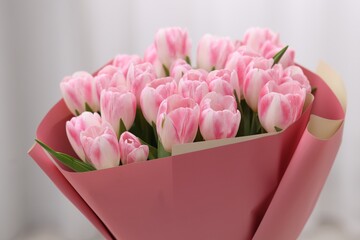 Beautiful bouquet of fresh pink tulips on blurred background, closeup