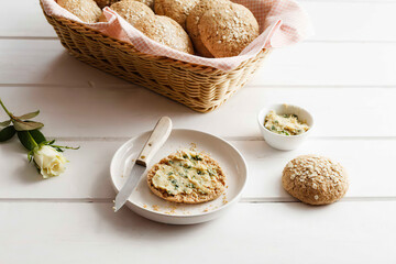 fresh tasty bread roll with spread on the table, healthy breakfast